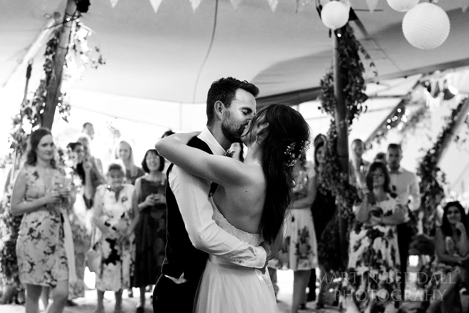 Festival style wedding kiss on the dance floor