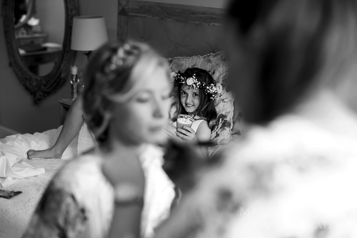 Flower girl watches the bride get ready