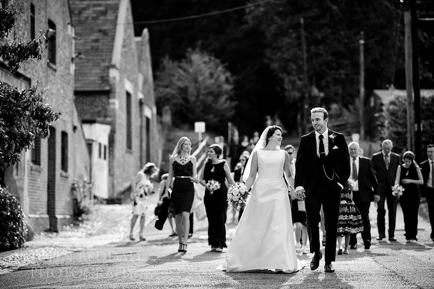 Brie and groom lead the guests to the reception at Folkington Manor