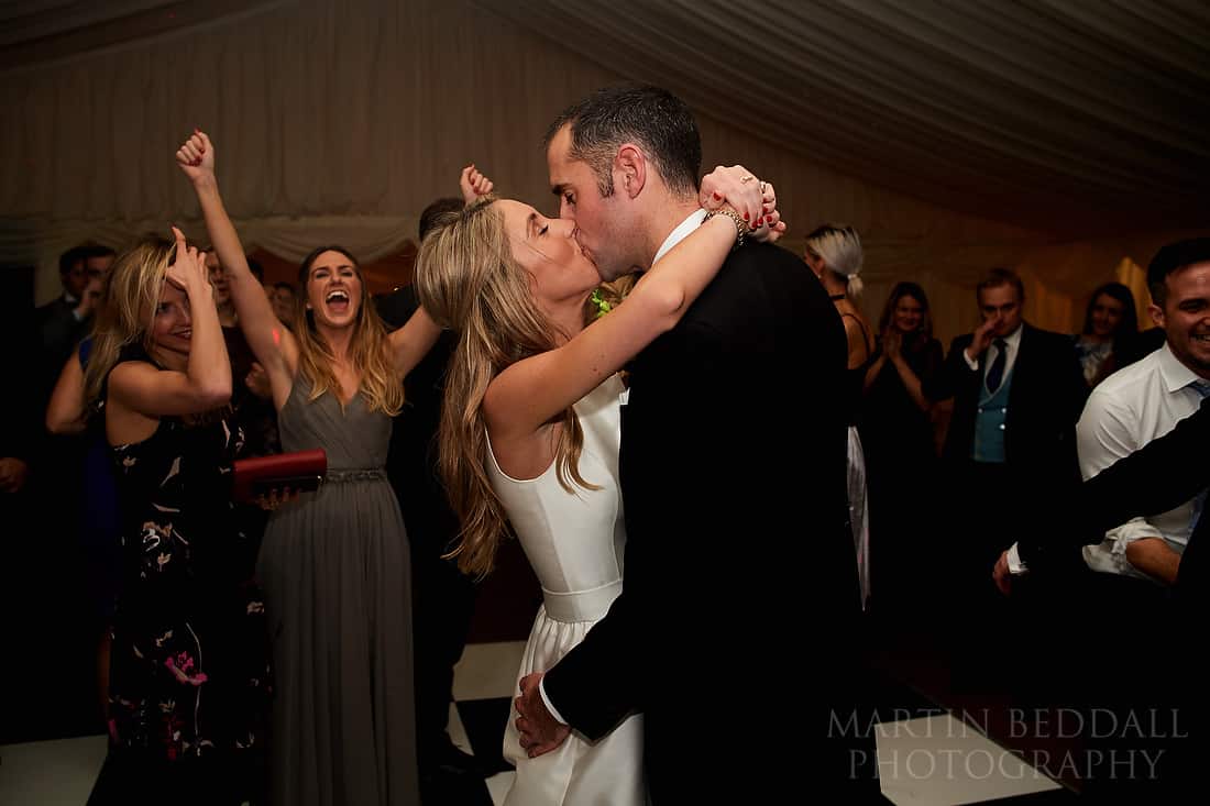 bride and groom kiss on the dancefloor