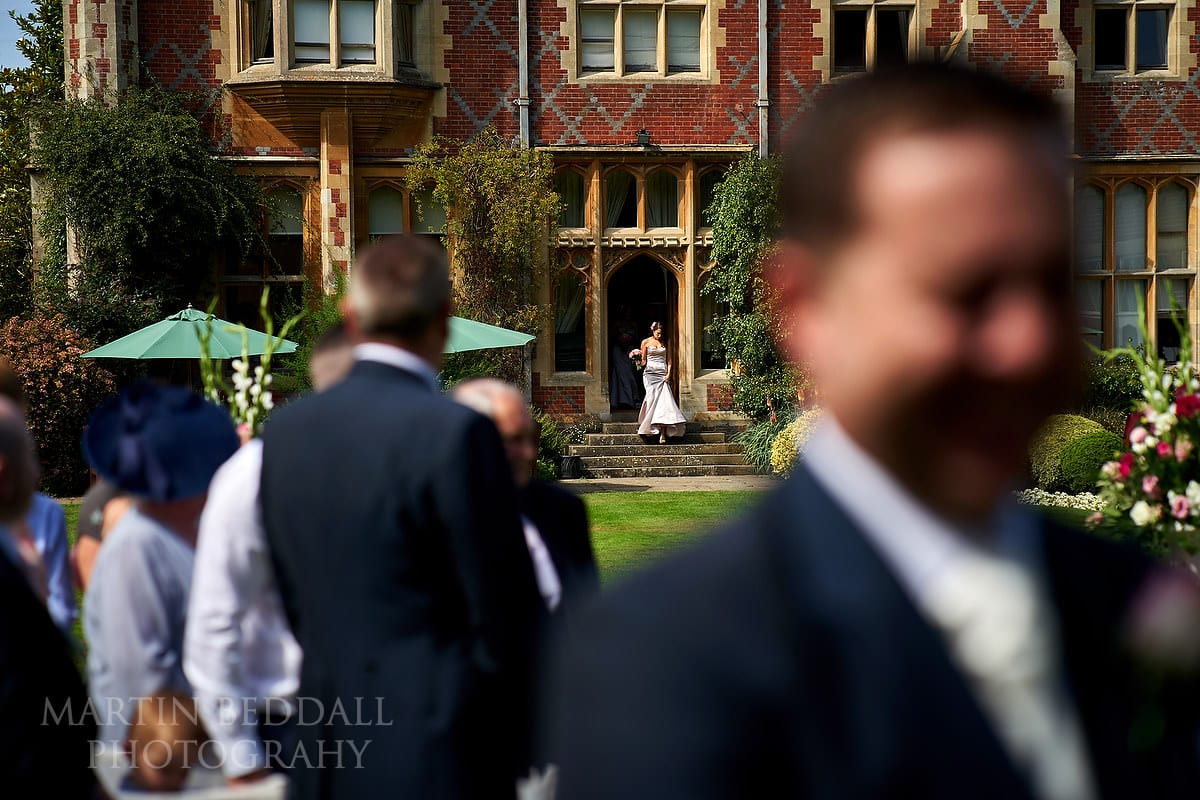 Bride heads out of Horsted Place for the ceremony