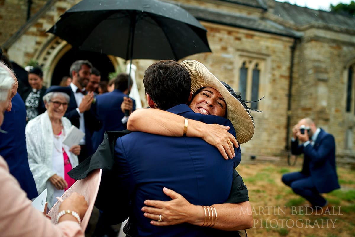 Groom's mother hugs her son after the wedding ceremony