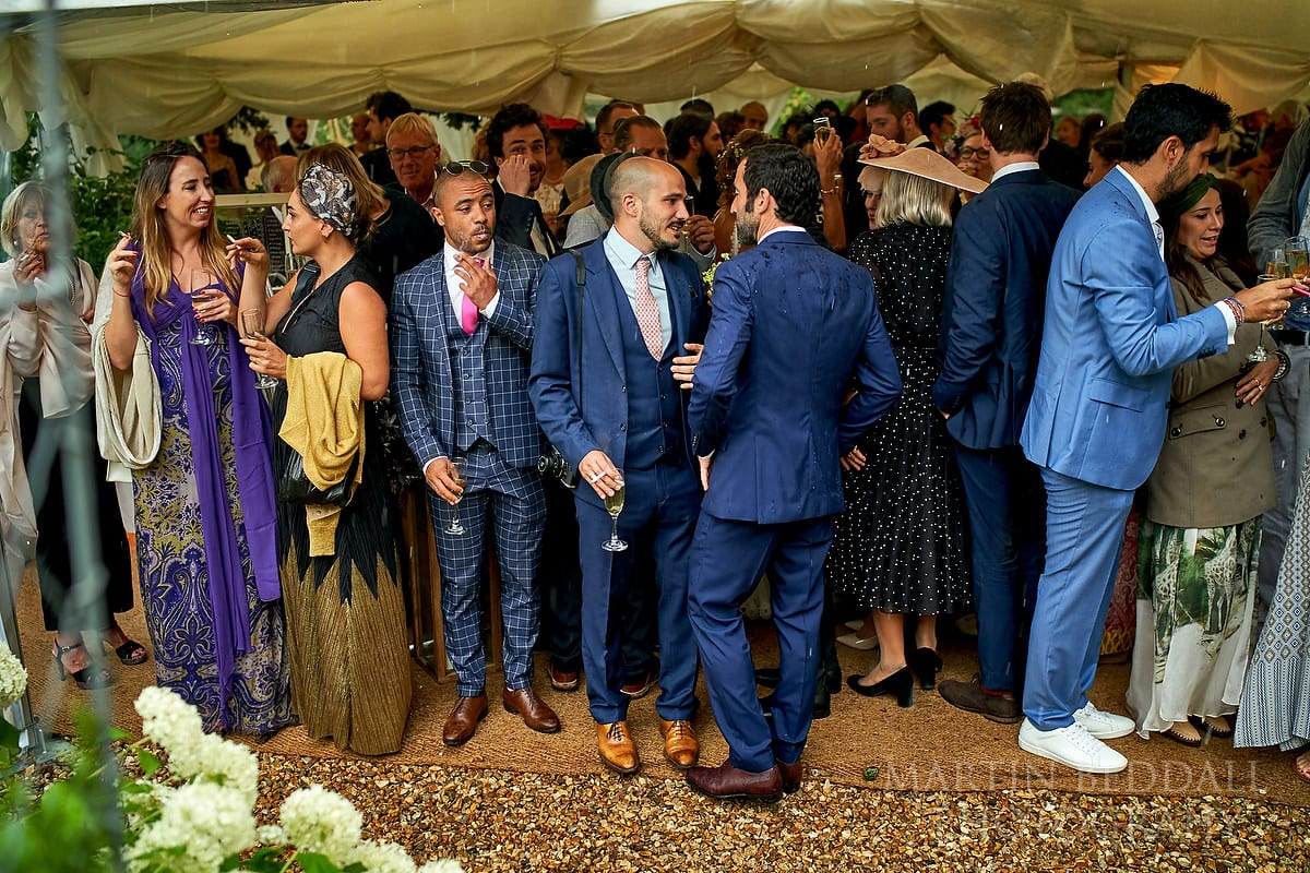 Wedding guests sheltering from the rain