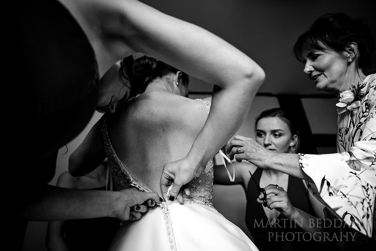 Fastening up the bride's dress