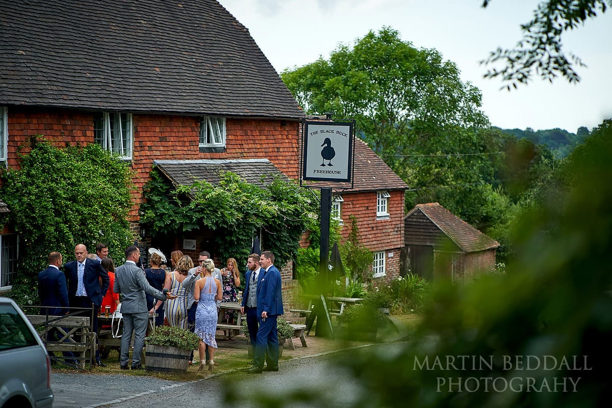 Groom and guests outside the village pub