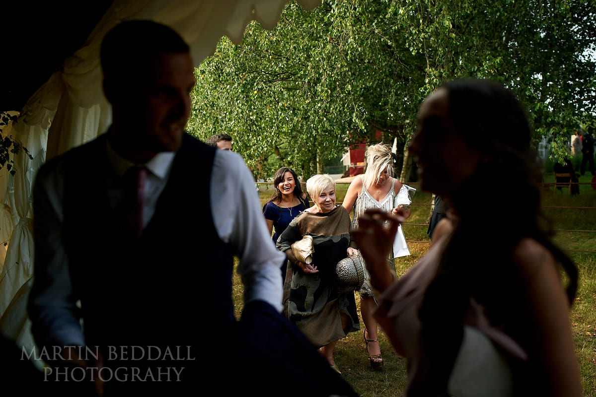 Guests enter the Marquee in the garden wedding