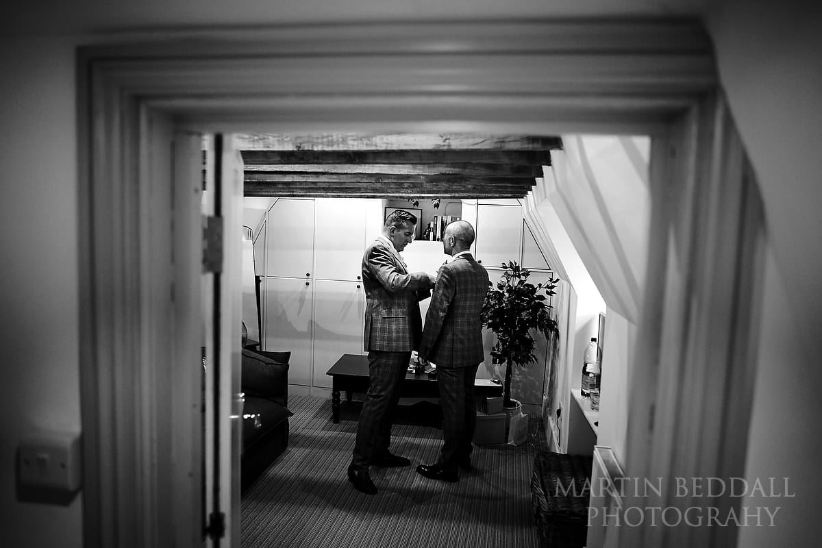 Two grooms in matching suits