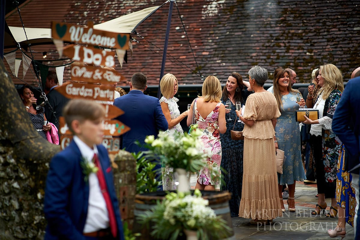 Wedding guests gather at Cissbury Barns