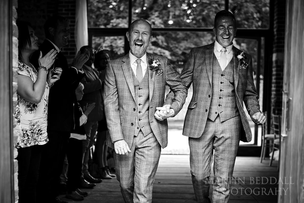 Two triumphant grooms