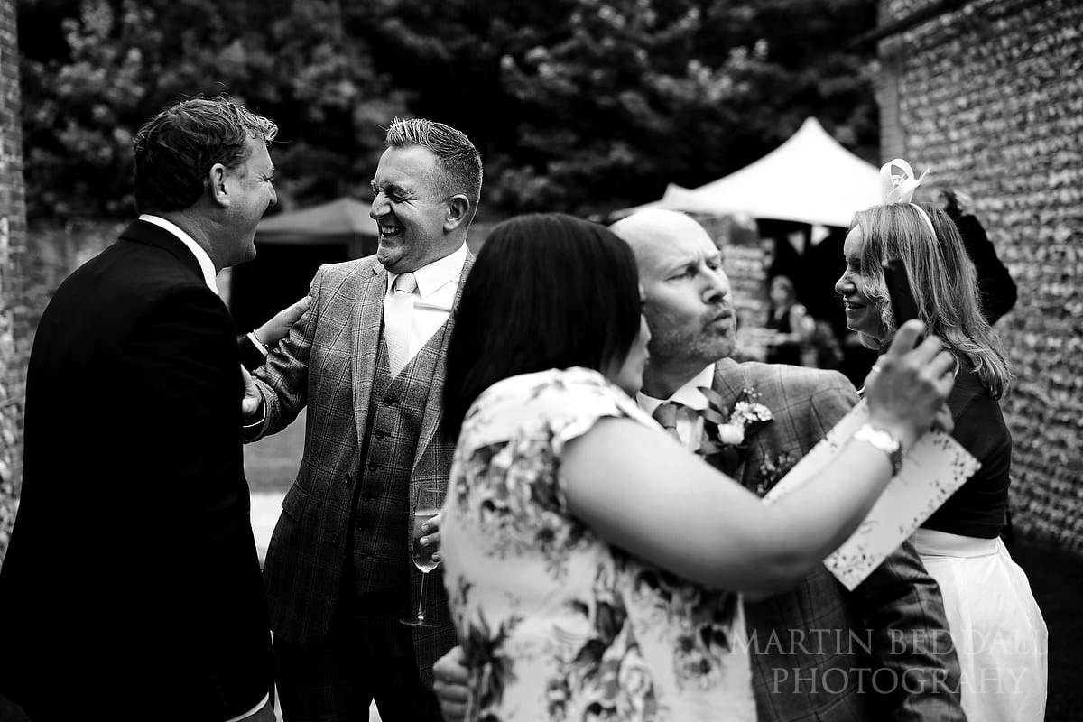 Grooms with friends outside the barns