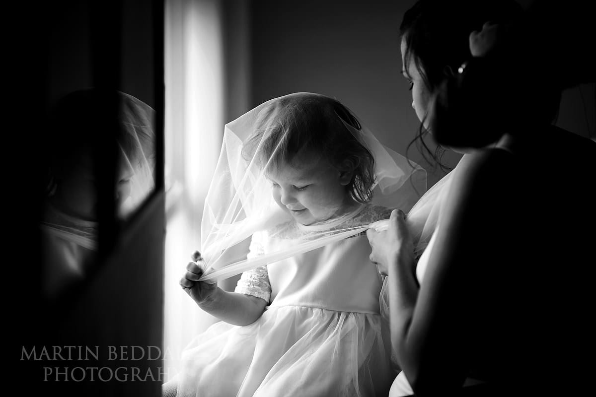 Bride's daughter plays with the veil