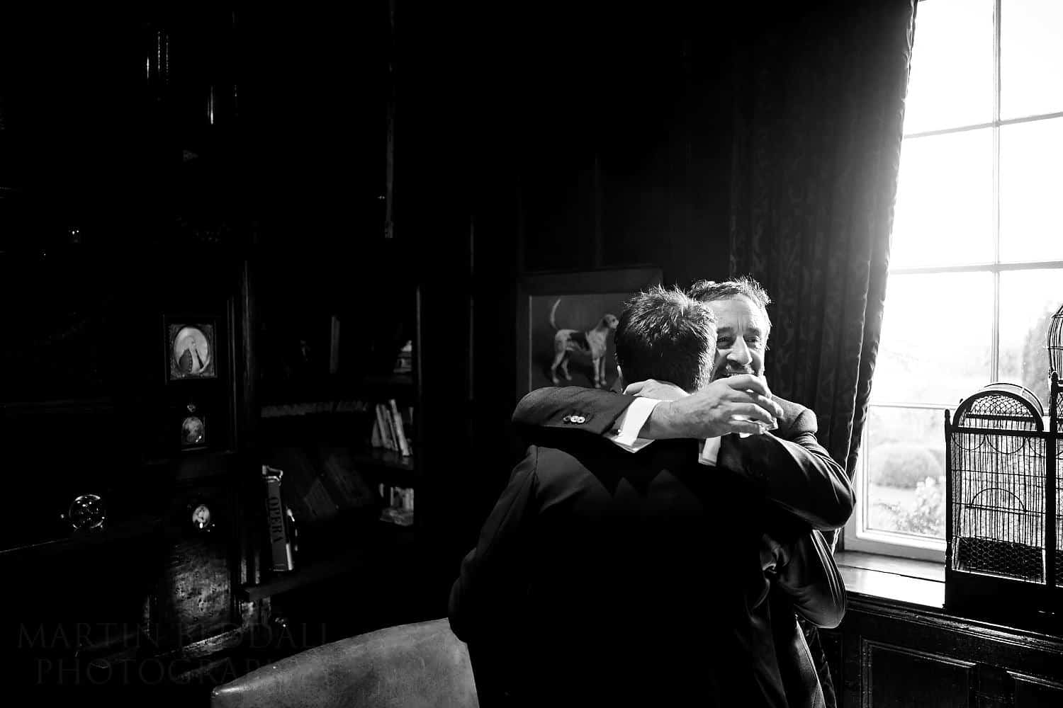 groom and his father hug