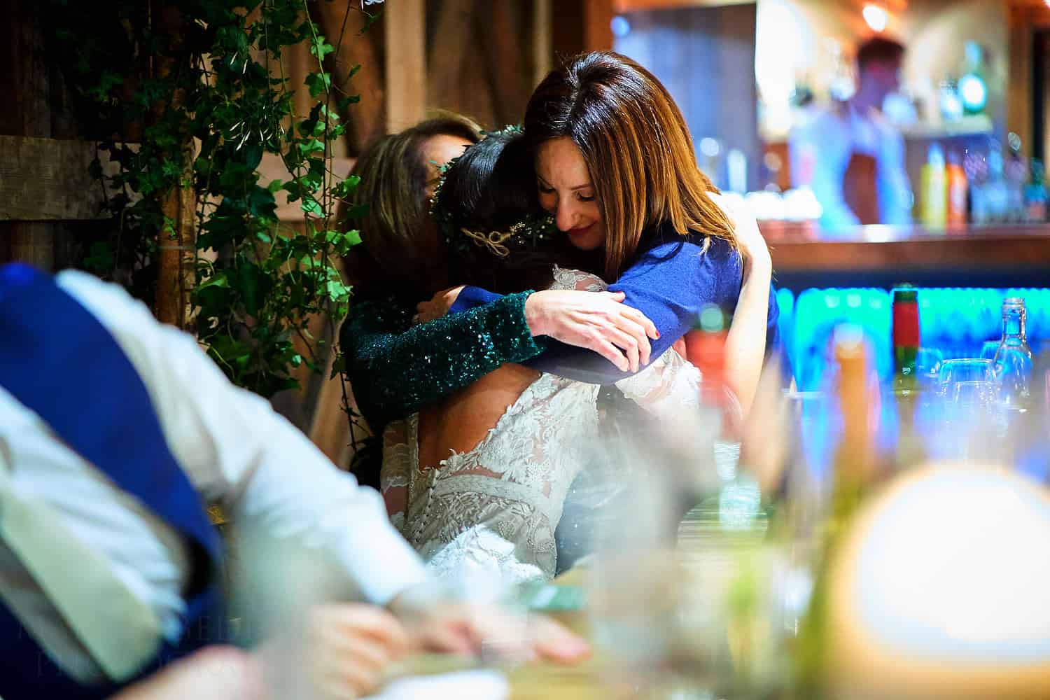 bride hugs mum and sister