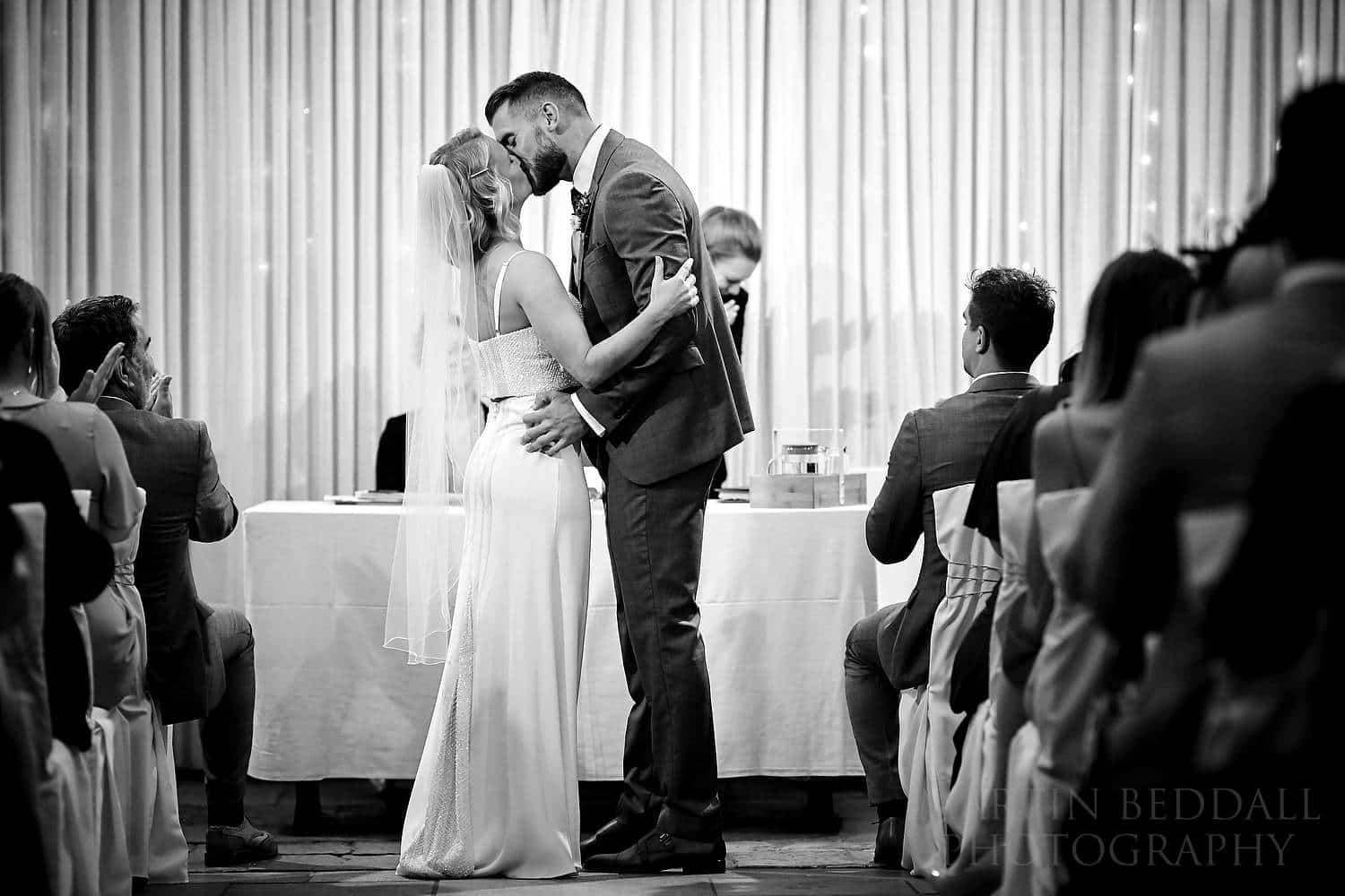 Bride and groom kiss at the Square Tower