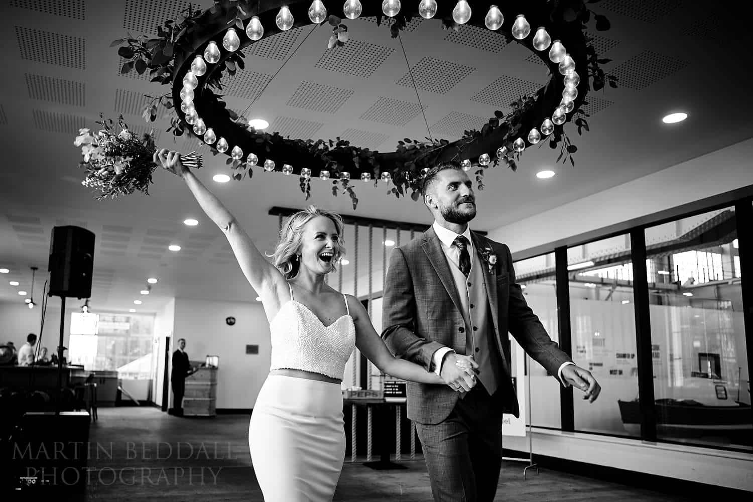 Bride sand groom make their entrance at Boathouse 4 wedding reception