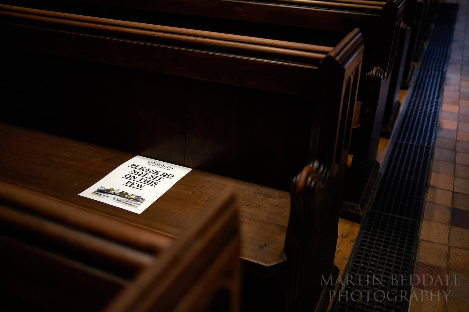 Notice on a church pew to conform with post-lockdown wedding regulations