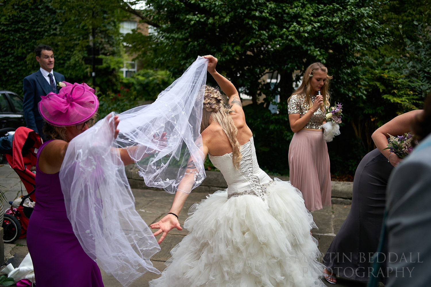 Wedding veil goes on outside the church