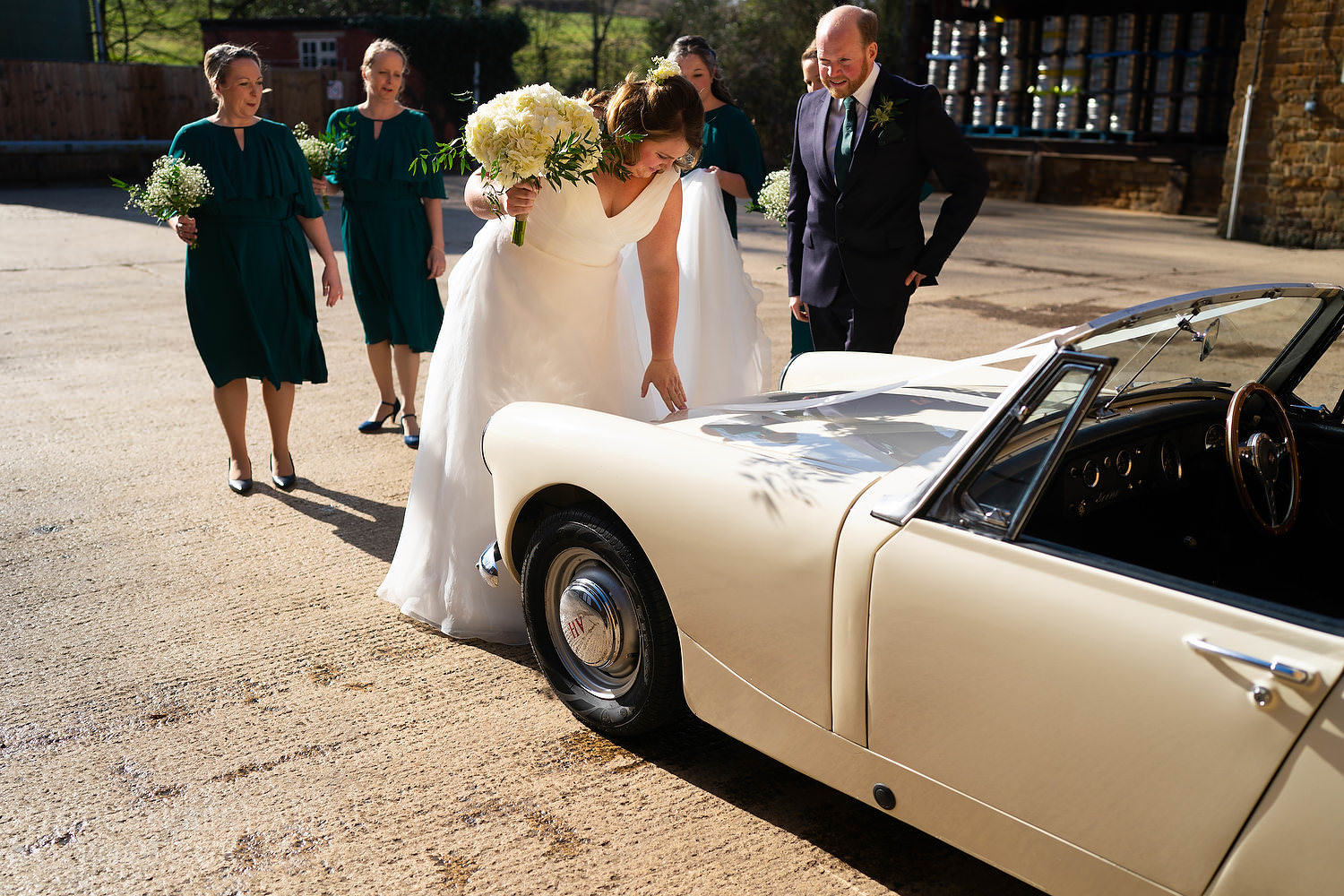 Bride touches her late father's car