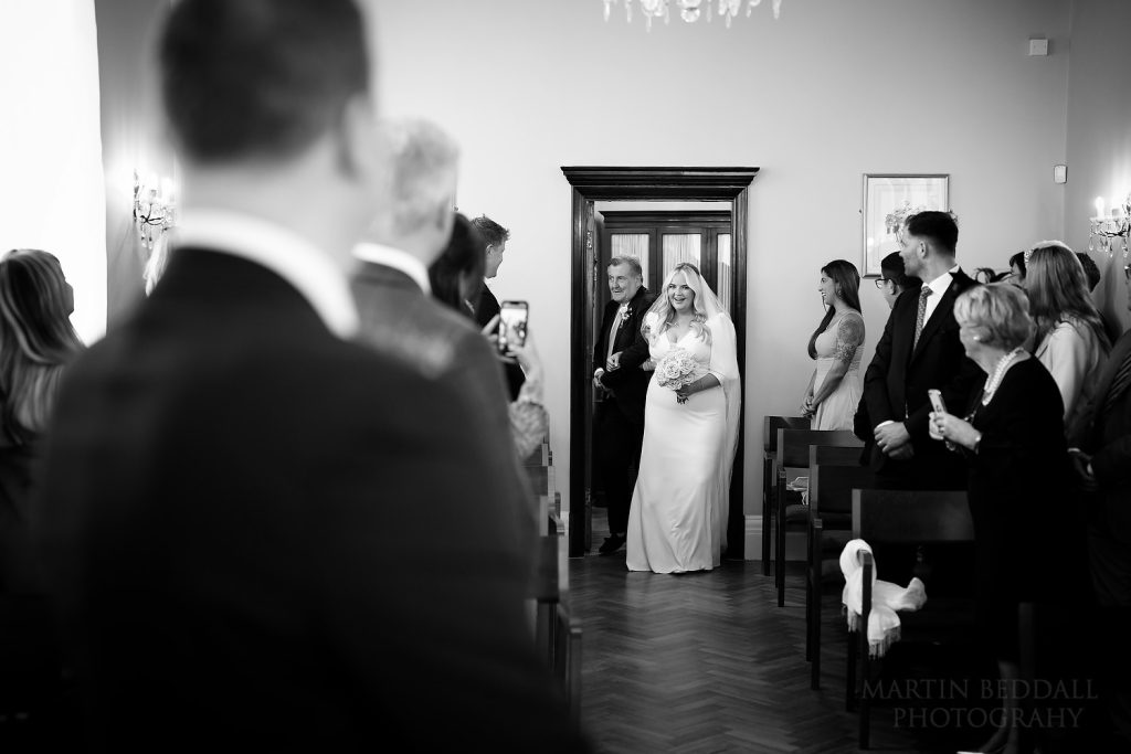 Bride and her father enter the ceremony room at Chelsea Town Hall