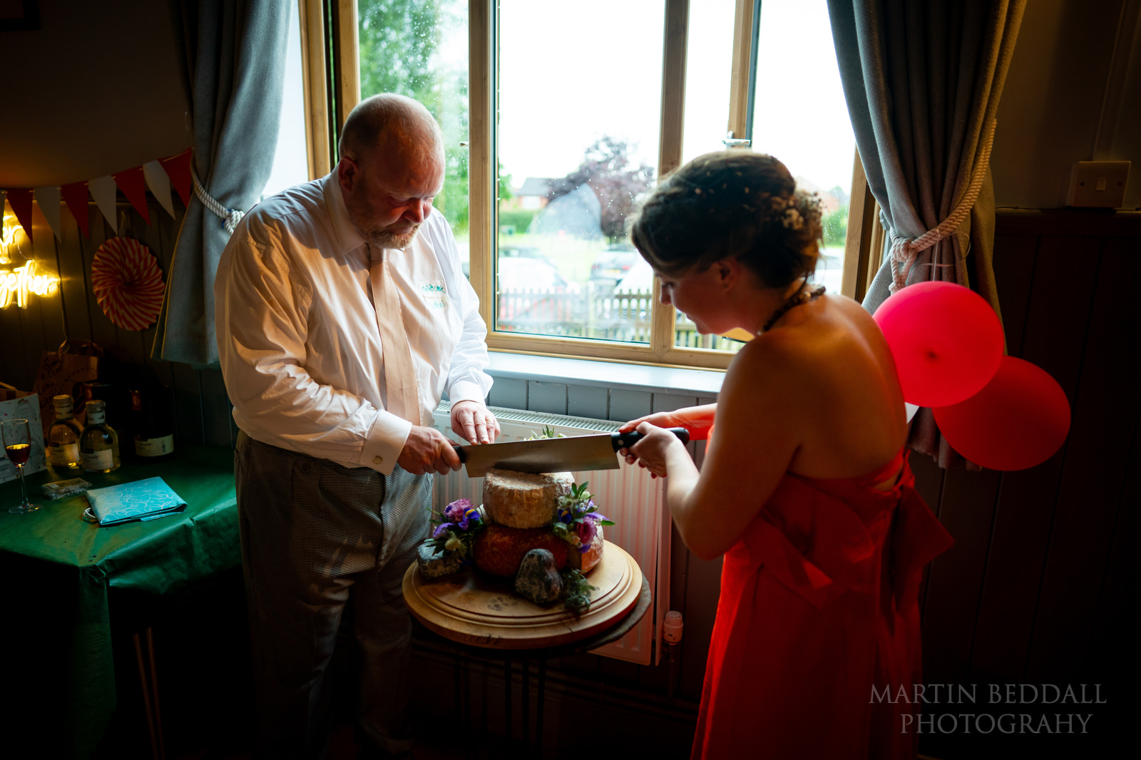 Cutting the wedding cake at Cheswardine wedding