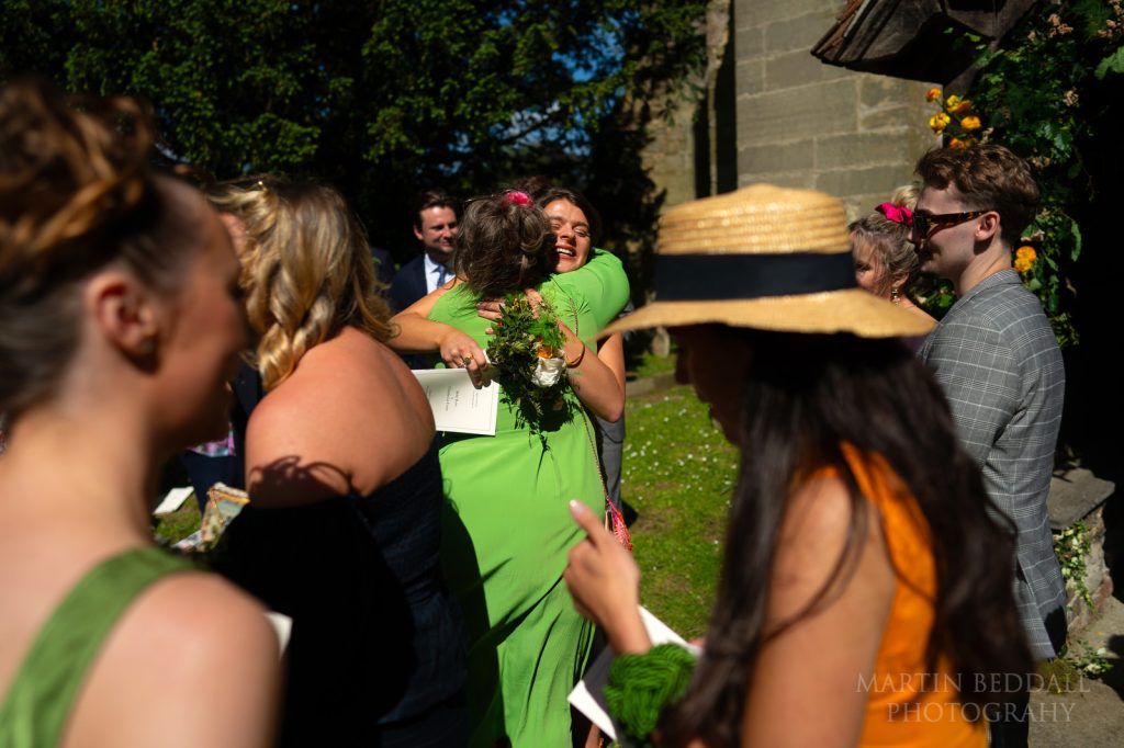 hugs outside the church in Kirdford